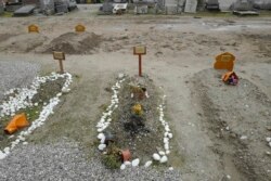 Recent tombs of migrants who died in their attempts to cross the English Channel are pictured in the Nord Cemetery of Calais, France, Nov. 25, 2021. At least 27 migrants died when their small boat sank in an attempted crossing of the channel, a French government official said.