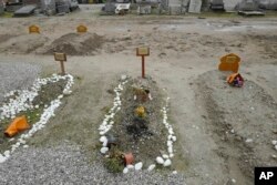 Recent tombs of migrants who died in their attempts to cross the English Channel are pictured in the Nord Cemetery of Calais, France, Nov. 25, 2021. At least 27 migrants died when their small boat sank in an attempted crossing of the channel, a French government official said.