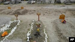 Recent tombs of migrants who died in their attempts to cross the English Channel are pictured in the Nord Cemetery of Calais, France, Nov. 25, 2021. At least 27 migrants died when their small boat sank in an attempted crossing of the channel, a French gov