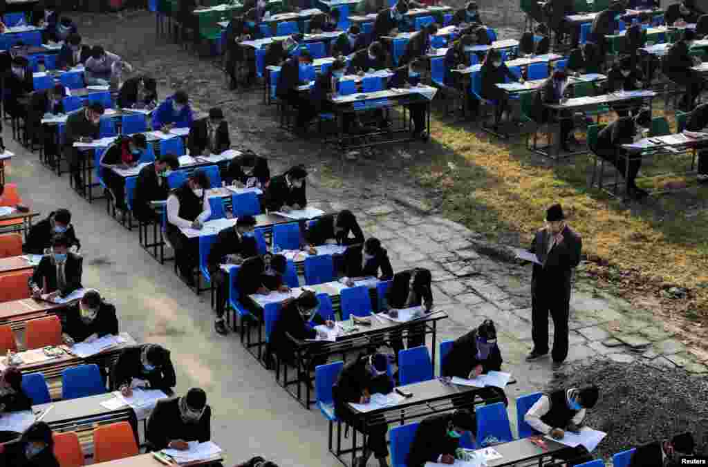 Students maintaining social distance and wearing protective face masks take their grade 12 exam, amid the spread of COVID-19 in Kathmandu, Nepal.