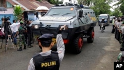 One of the Indonesian police armored vehicles carrying two Australian prisoners arrives at Wijaya Pura port in Cilacap, Central Java, Indonesia, Wednesday, March 4, 2015.