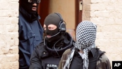 French members of the French National Police Intervention Group (GIPN) arrest a suspected radical Islamist group member, on April 4, 2012, in Roubaix.