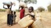 Children carry their family's belongings as they go to Yida refugee camp in South Sudan outside Tess village in the rebel-held territory of the Nuba Mountains in South Kordofan, May 2, 2012. 