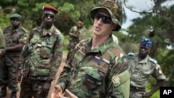 U.S. Army special forces Captain Gregory, 29, from Texas, center, who would only give his first name in accordance with special forces security guidelines, speaks with troops from the Central African Republic and Uganda, in Obo, Central African Republic, 