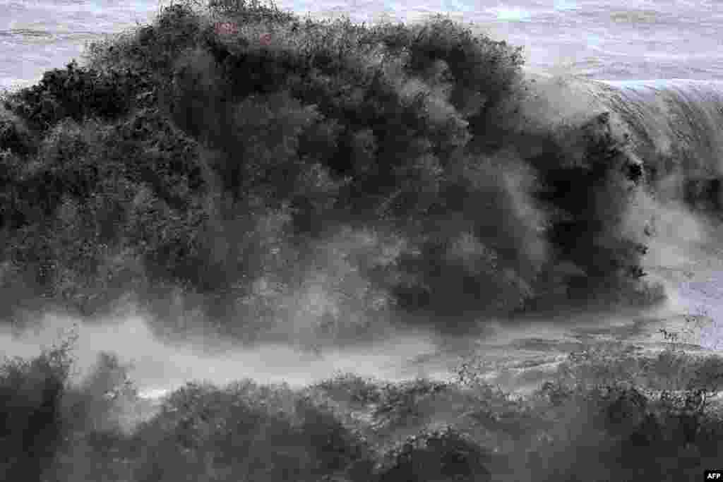 A strong wave hits the shore in Saint-Joseph, on the French Indian Ocean island of La Reunion, as the tropical storm Beguitta passes near the island.