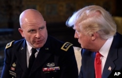 FILE - President Donald Trump, right, listens to Army Lt. Gen. H.R. McMaster, at the time national security adviser-designate, left, at Trump's Mar-a-Lago estate in Palm Beach, Florida, Feb. 20, 2017.