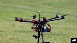 FILE - A small hexacopter drone is pictured during a demonstration in Cordova, Md.