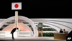 Japan's Prime Minister Shinzo Abe, left, bows to Emperor Akihito and Empress Michiko during the national memorial service for the victims of the March 11, 2011 earthquake and tsunami, in Tokyo Wednesday, March 11, 2015.