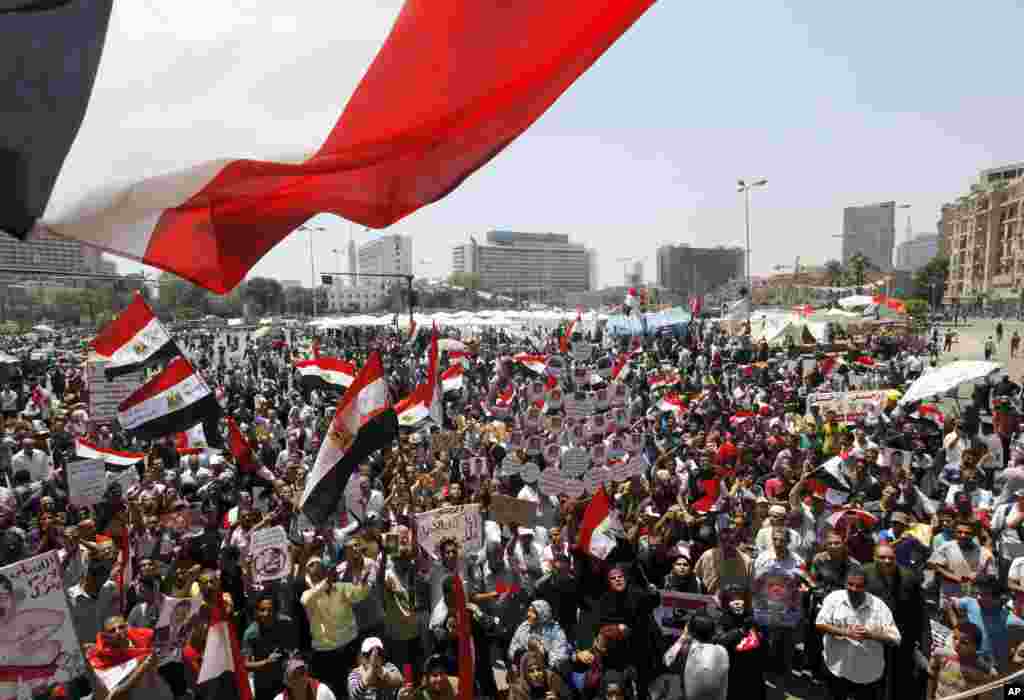 Opponents of Egypt's Islamist President Mohamed Morsi wave national flags in Tahrir Square in Cairo, June 28, 2013.