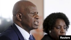 Zimbabwe's Finance Minister Patrick Chinamasa (L) addresses a media conference after meeting International Monetary Fund (IMF) Executive Director for Africa Chileshe Kapwepwe (R) in Harare, September 7, 2015.