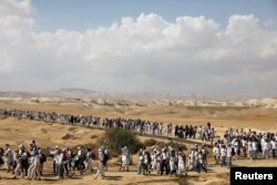 Palestinian and Israeli women march, as part of an event organized by "Women Wage Peace" group calling for an end to the Israeli-Palestinian conflict, near the Jordan River, in the occupied West Bank, Oct. 8, 2017.