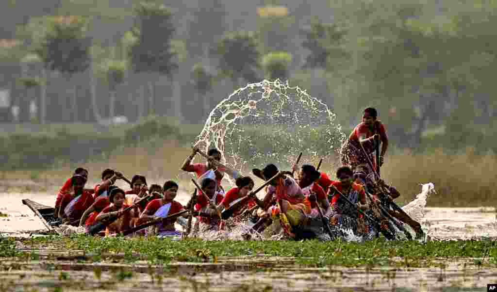 October 27: Indian village women participate in a boat race competition - a ritual after the festival of Diwali, in Habra, India. (AP Photo)