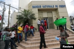 People line up outside a bank at a neighborhood in Port-au-Prince, Haiti, Feb. 16, 2019.