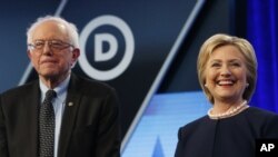 FILE - Democratic presidential candidates Bernie Sanders (I-Vt.) and Hillary Clinton appear at a debate in Miami, March 9, 2016. 