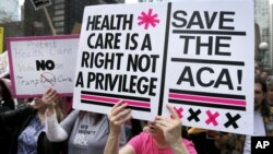 FILE - Protesters gather across the Chicago River from Trump Tower to rally against the repeal of the Affordable Care Act, March 24, 2017, in Chicago. 