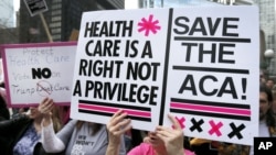 FILE - Protesters gather across the Chicago River from Trump Tower to rally against the repeal of the Affordable Care Act, March 24, 2017, in Chicago. 