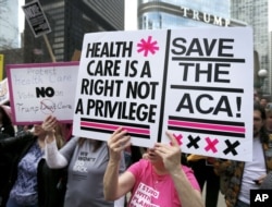 FILE - Protesters gather across the Chicago River from Trump Tower to rally against the repeal of the Affordable Care Act, March 24, 2017, in Chicago.