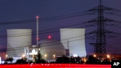 The blur of car lights passing by the nuclear power plant Biblis, south of Frankfurt, central Germany, in a Jan 23, 2006 file photo. Germany's plan to start shutting down its 17 nuclear reactors as early as next year. (AP Photo/Michael Probst)