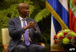 FILE - Haiti's President Jovenel Moise gestures during a meeting with Cuban President Miguel Diaz-Canel (not shown) at Revolution Palace in Havana, Dec. 3, 2018.