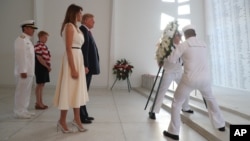 U.S. President Donald Trump and first lady Melania Trump lay a wreath at the USS Arizona Memorial in Pearl Harbor, Honolulu, Hawaii, Nov. 3, 2017. Trump begins a five-country trip through Asia traveling to Japan, South Korea, China, Vietnam and the Philippines.
