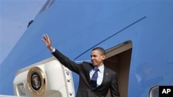 President Barack Obama waves before his departure from Los Angeles International airport in Los Angeles, April 22, 2011