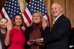 House Speaker Nancy Pelosi of Calif., right, poses during a ceremonial swearing-in with Rep. Pete Stauber, R-Minn., on Capitol Hill in Washington, Thursday, Jan. 3, 2019, during the opening session of the 116th Congress. Washington, Thursday, Jan. 3, 2019.