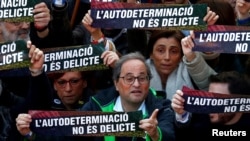 FILE - Catalan Regional President Quim Torra takes part during a rally of Catalan separatist organizations to demonstrate against the trial of Catalan leaders and call for self-determination rights in Barcelona, Spain, Feb. 16, 2019.