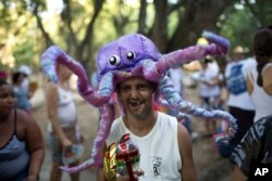 A patient from the Nise da Silveira Mental Health Institute wears an octopus costume during the institute's carnival parade, coined in Portuguese: "Loucura Suburbana," or Suburban Madness, in the streets of Rio de Janeiro, Brazil, Feb. 23, 2017. Patients, their relatives and institute workers held their parade one day before the official start of Carnival.