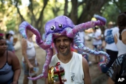 A patient from the Nise da Silveira Mental Health Institute wears an octopus costume during the institute's carnival parade, coined in Portuguese: "Loucura Suburbana," or Suburban Madness, in the streets of Rio de Janeiro, Brazil, Feb. 23, 2017. Patients, their relatives and institute workers held their parade one day before the official start of Carnival.