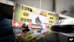 FILE: In this Jan.26 2016 photo, striking taxi drivers demonstrate in Paris against what they consider unfair competition from rival services such as Uber. The European Union's top court ruled Dec.20 2017 that Uber can be regulated like a taxi company, changing how it functions.
