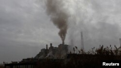 FILE - Smoke rises from a coal-fired power plant in Obilic near Pristina, Kosovo, Nov. 1, 2018. 