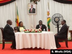 Members of Zimbabwe’s Cabinet took the oath of office, Dec. 04, 2017, to work under new President Emmerson Mnangagwa (2nd left).