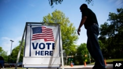 FILE - A voter leaves a polling site after casting a ballot in a special election in Marietta, Ga.