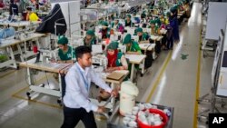 FILE - Trainees work at a garment factory in Dhamrai, near Dhaka, Bangladesh, April 19, 2018.