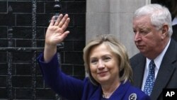 US Secretary of State Hillary Rodham Clinton (l) with U.S. Ambassador to the UK, Louis Susmana, ahead of a meeting of international allies to discuss the next steps for Libya, March 29, 2011