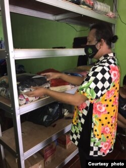 A FKWI Laundry worker puts away pressed and folded laundry. (Courtesy - FKWI)