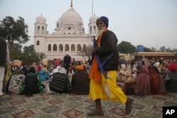 A Sikh pilgrim visits the shrine of their spiritual leader Guru Nanak Dev in Kartarpur, Pakistan, Nov. 28, 2018.