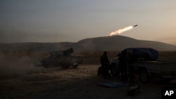 Kurdish Peshmerga soldiers fire artillery at Islamic State positions in Bashiqa, east of Mosul, Iraq, Nov. 7, 2016.