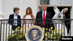 U.S. President Donald Trump stands with his son Barron (L-R), first lady Melania Trump and a performer in an Easter Bunny costume on the Truman Balcony during the White House Easter Egg Roll in Washington, U.S., April 17, 2017. REUTERS/Joshua Roberts