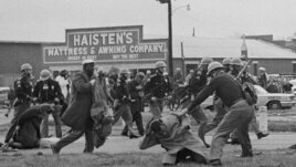 State troopers swing billy clubs to break up a civil rights voting march in Selma, Ala., March 7, 1965. John Lewis, chairman of the Student Nonviolent Coordinating Committee (in the foreground) is being beaten by a state trooper.