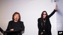 Singer Ozzy Osbourne, right, and musician Geezer Butler of the rock band Black Sabbath pose for a portrait, June 6, 2013 in Los Angeles.