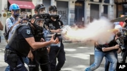 Police fire tear gas as riot police spray water cannon at demonstrators who remained defiant after authorities evicted activists from an Istanbul park, June 16, 2013.
