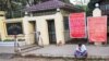 FILE - A man sits in front of Insein prison in Yangon on April 12, 2021, while waiting to visit inmates ahead of the long holiday stretch for the Myanmar New Year, also known as Thingyan, as the country remains in turmoil after the February military coup.