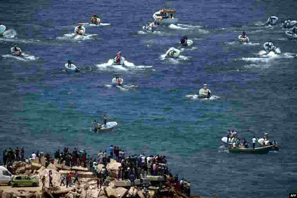 Fishing boats carry a group of Palestinian activists who are protesting and perhaps trying to breach Israel&#39;s naval blockade on Gaza, boating from Gaza City harbor. The Gaza Strip has been under Israeli blockade for more than a decade, with Israel saying it is necessary to prevent the Palestinian enclave&#39;s militant Hamas rulers from obtaining the means to attack the Jewish state.