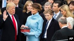 Donald Trump is sworn in as the 45th president of the United States by Chief Justice John Roberts as Melania Trump looks on during the 58th Presidential Inauguration at the U.S. Capitol in Washington, Friday, Jan. 20, 2017. (AP Photo/Andrew Harnik)