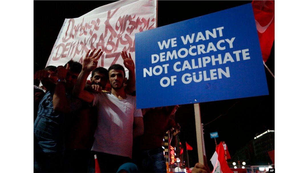 Supporters of Turkish President Recep Tayyip Erdogan hold a placard during a pro-government rally at Kizilay main square, in Ankara, Turkey, July 20, 2016.