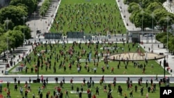 Workers unions keep a safe distance from each other and wear face masks to help protect against the spread of the new coronavirus during an event marking May Day in Lisbon, Portugal.