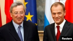 FILE - Poland's Prime Minister Donald Tusk (R) and Luxemburg's Prime Minister Jean-Claude Juncker posse to the media during their meeting at Prime Minister Chancellery in Warsaw April 29, 2009.