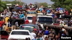 Venezuelans line up to cross into Colombia at the border in Paraguachon, Colombia, Feb. 16, 2018.