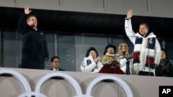 Thomas Bach, president of the International Olympic Committee, and South Korean President Moon Jae-in wave during the closing ceremony of the 2018 Winter Olympics in Pyeongchang, South Korea, Feb. 25, 2018.